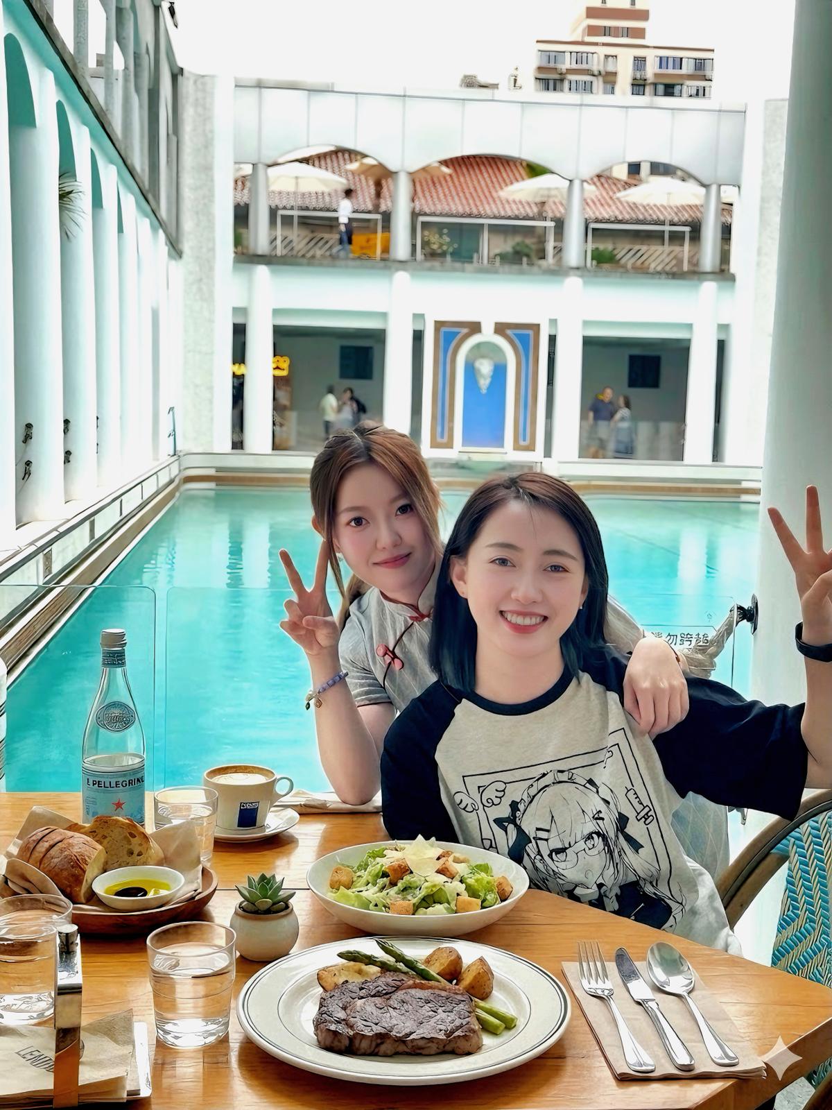 Your Shanghai Unlocked companions — Feier and Tang, relaxed and smiling by the riverside